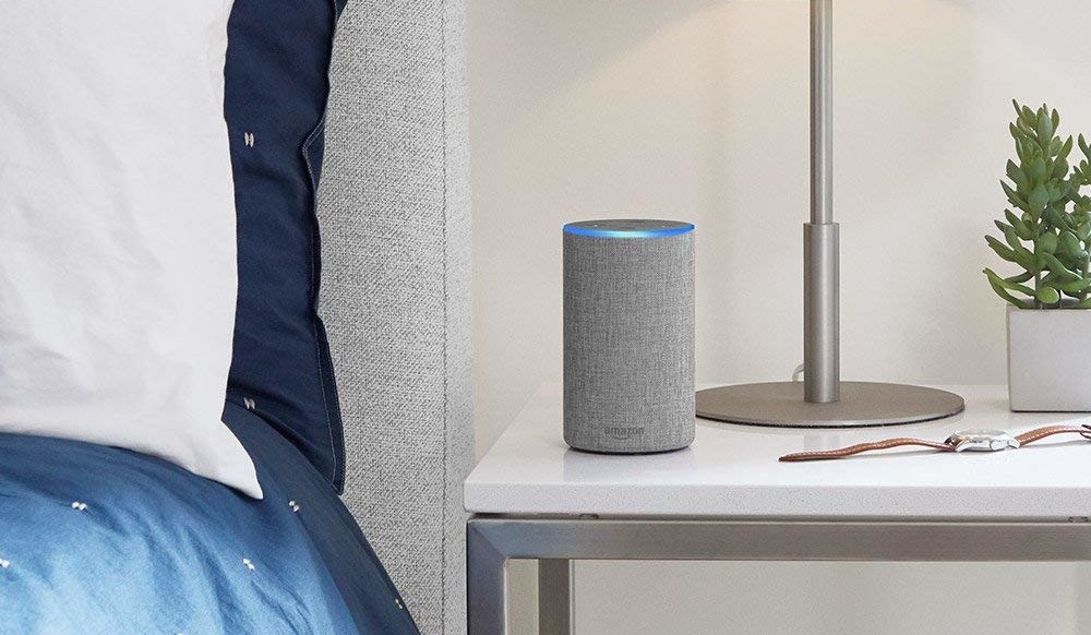 amazon echo on table next to bed