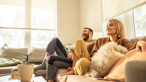 couple laughing watching tv