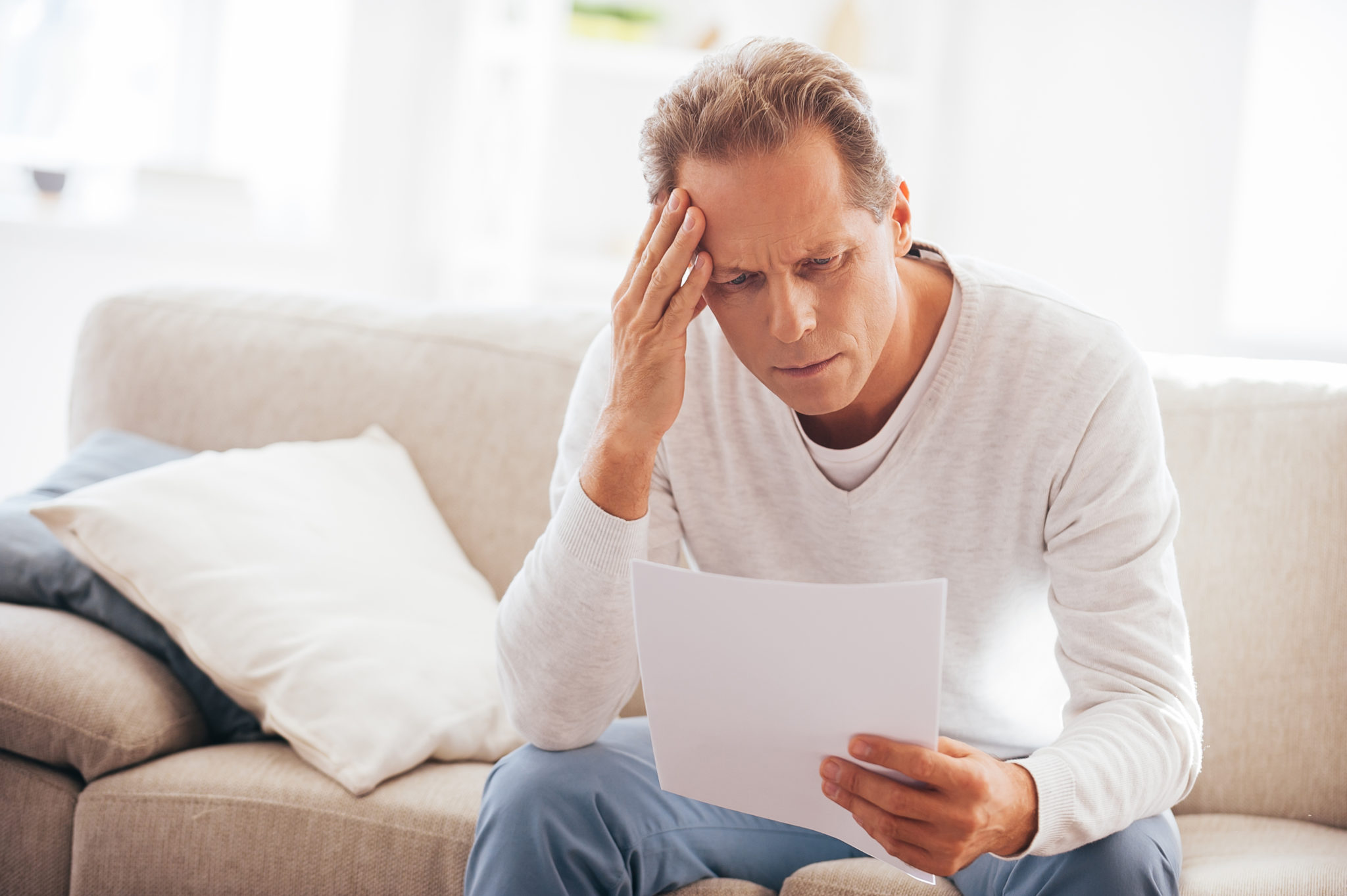 Man stressed over piece of paper