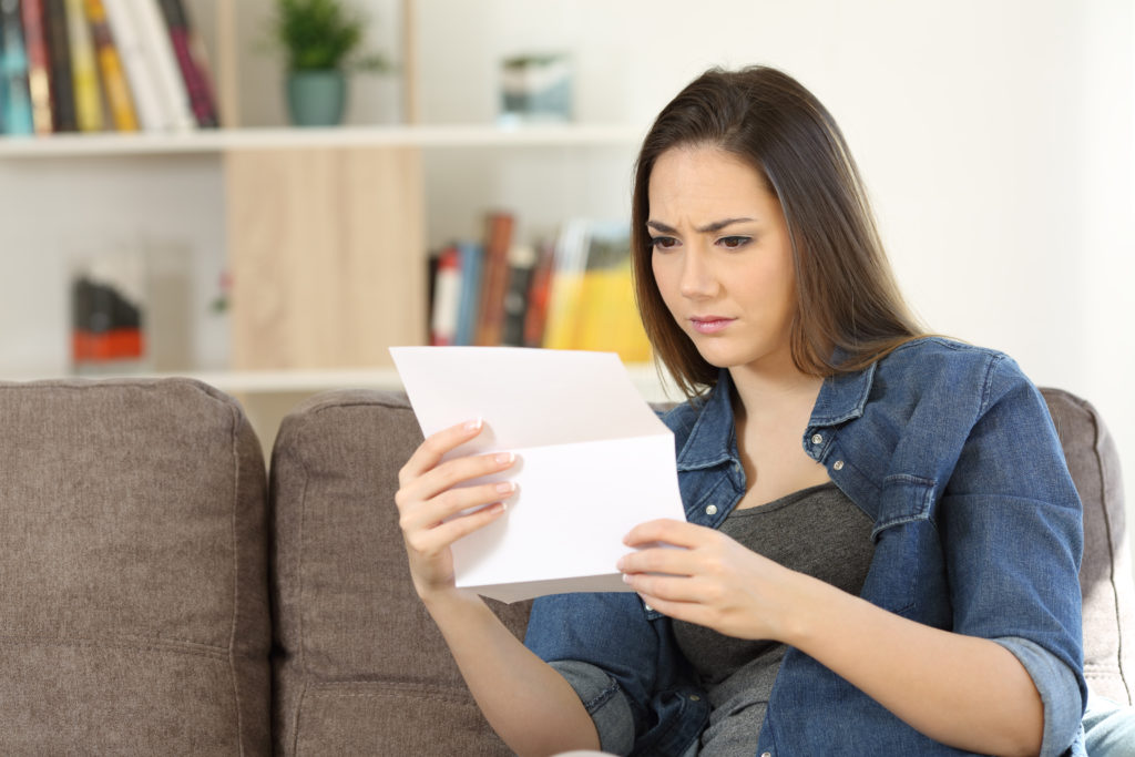 Worried woman reading paper